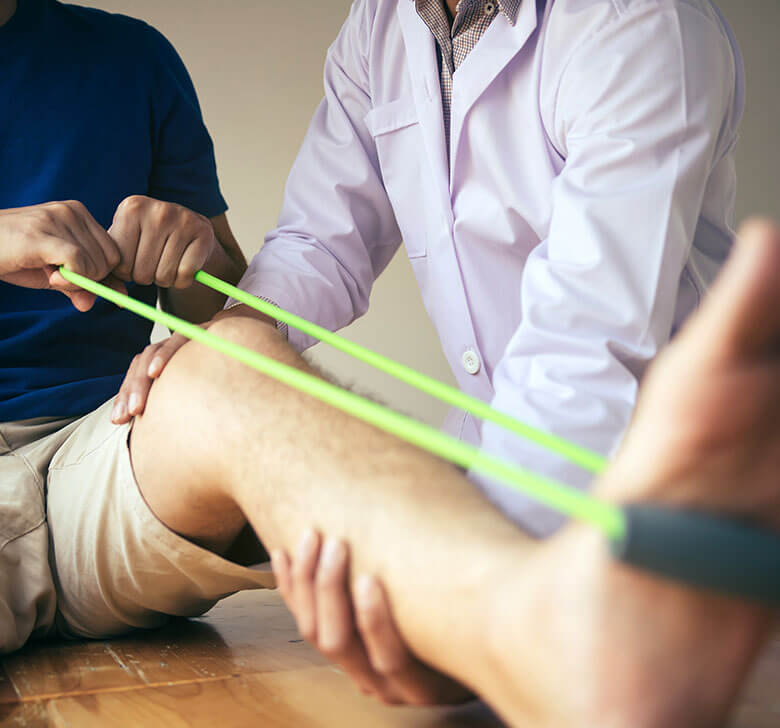 Patient use resistance band stretching out his leg